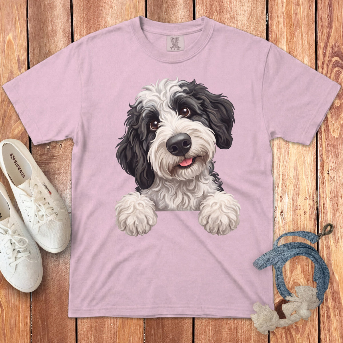 Pink t-shirt with a black and white doodle dog illustration and white Superga sneakers.