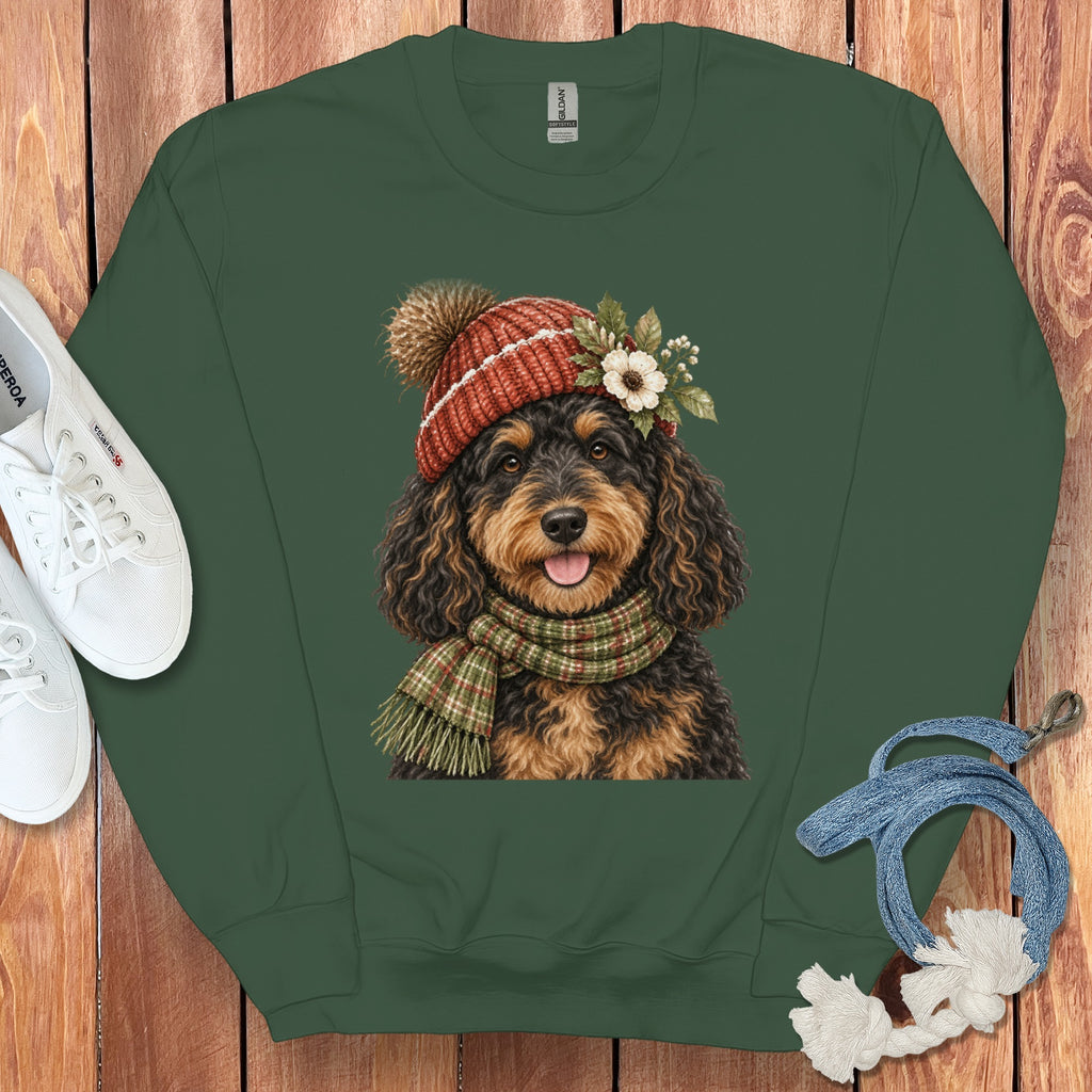 Green crewneck sweatshirt with a watercolor dog wearing a winter hat and scarf.