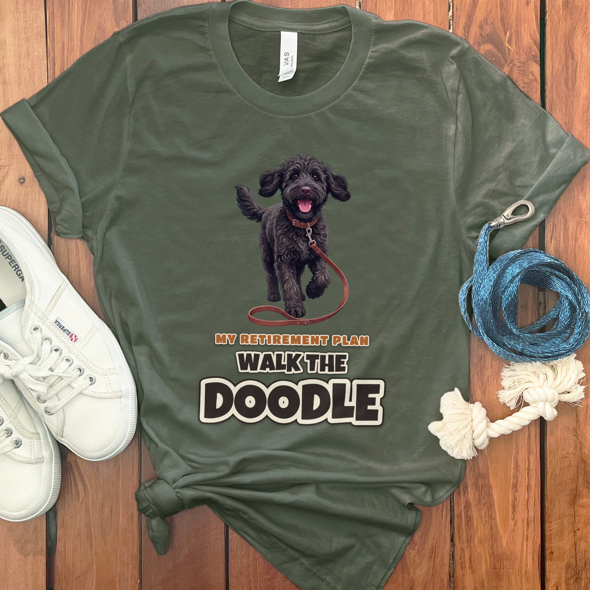 Green t-shirt with black doodle dog graphic and text: My Retirement Plan Walk The Doodle.