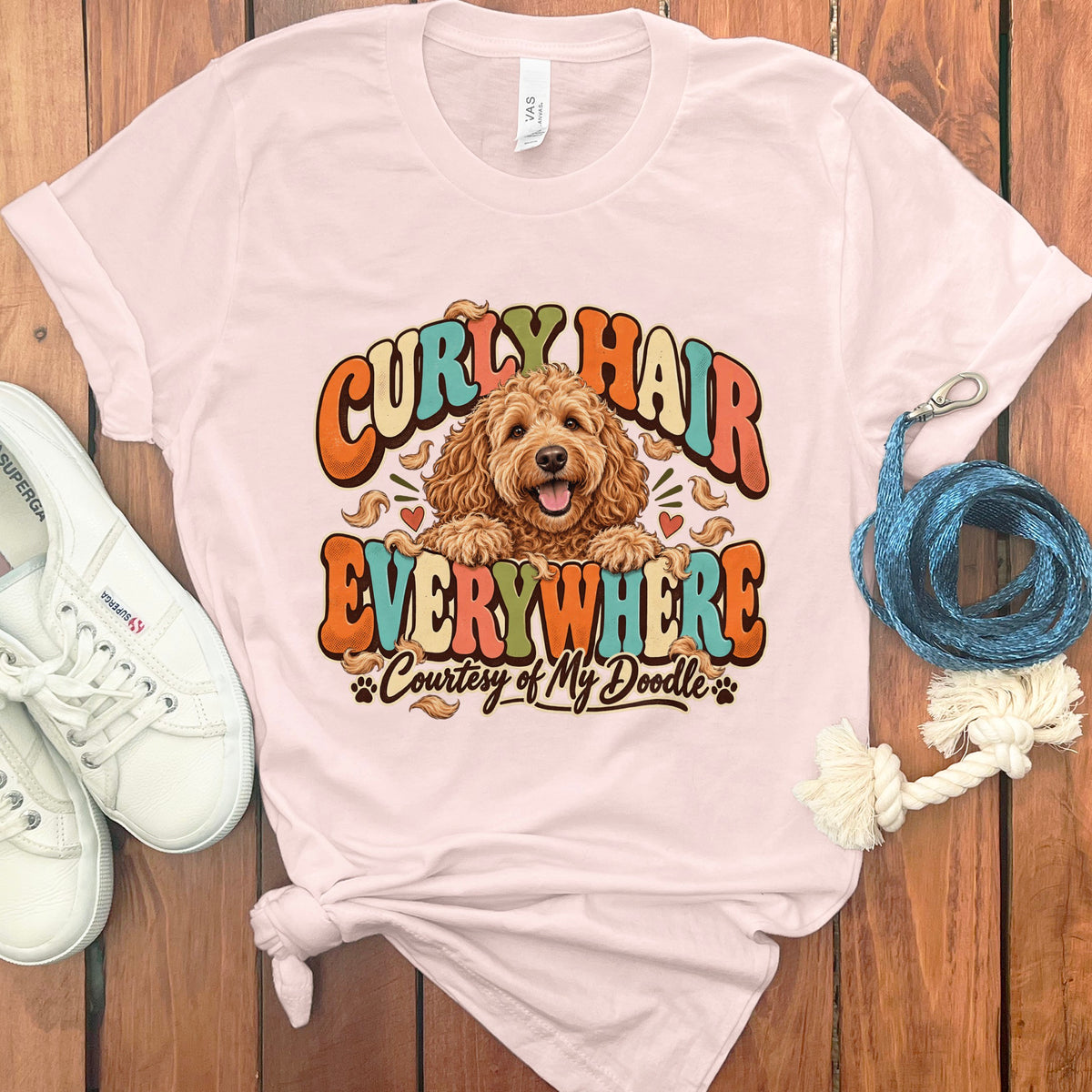 Pink t-shirt with "Curly Hair Everywhere Courtesy of My Doodle" text and a doodle.