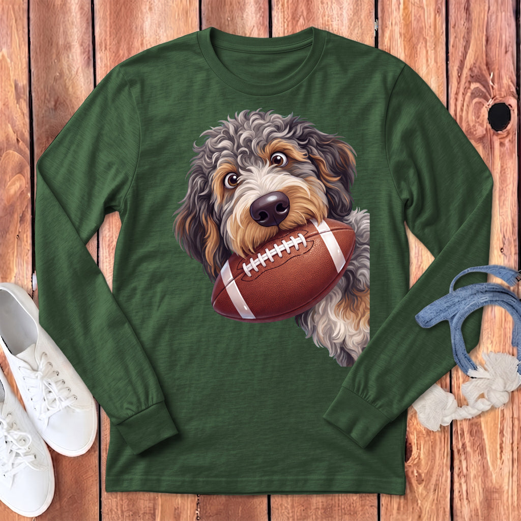 A dark green long-sleeve shirt displays an illustration of a fluffy dog holding a football.