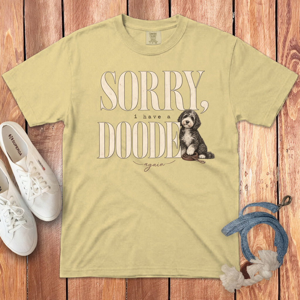 Yellow crewneck t-shirt featuring text that reads SORRY, i have a DOODE again, and an illustration of a doodle dog.