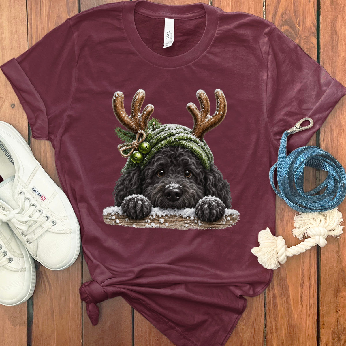 Maroon t-shirt with a black dog wearing reindeer antlers and a winter hat.