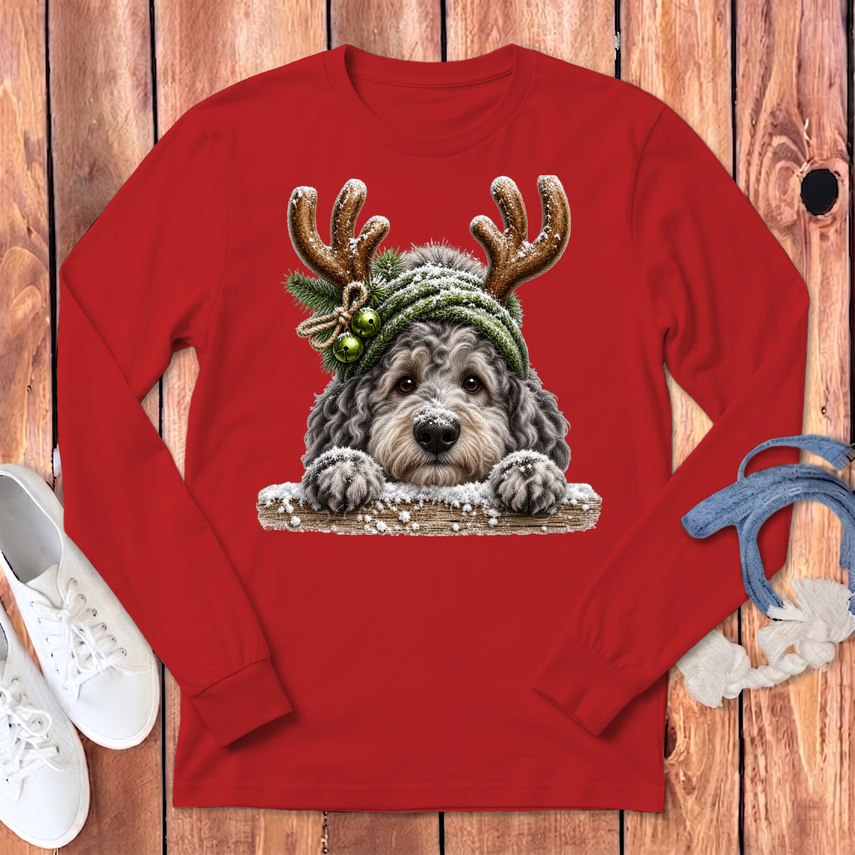 Red long-sleeve shirt with a fluffy dog wearing antlers and a beanie.