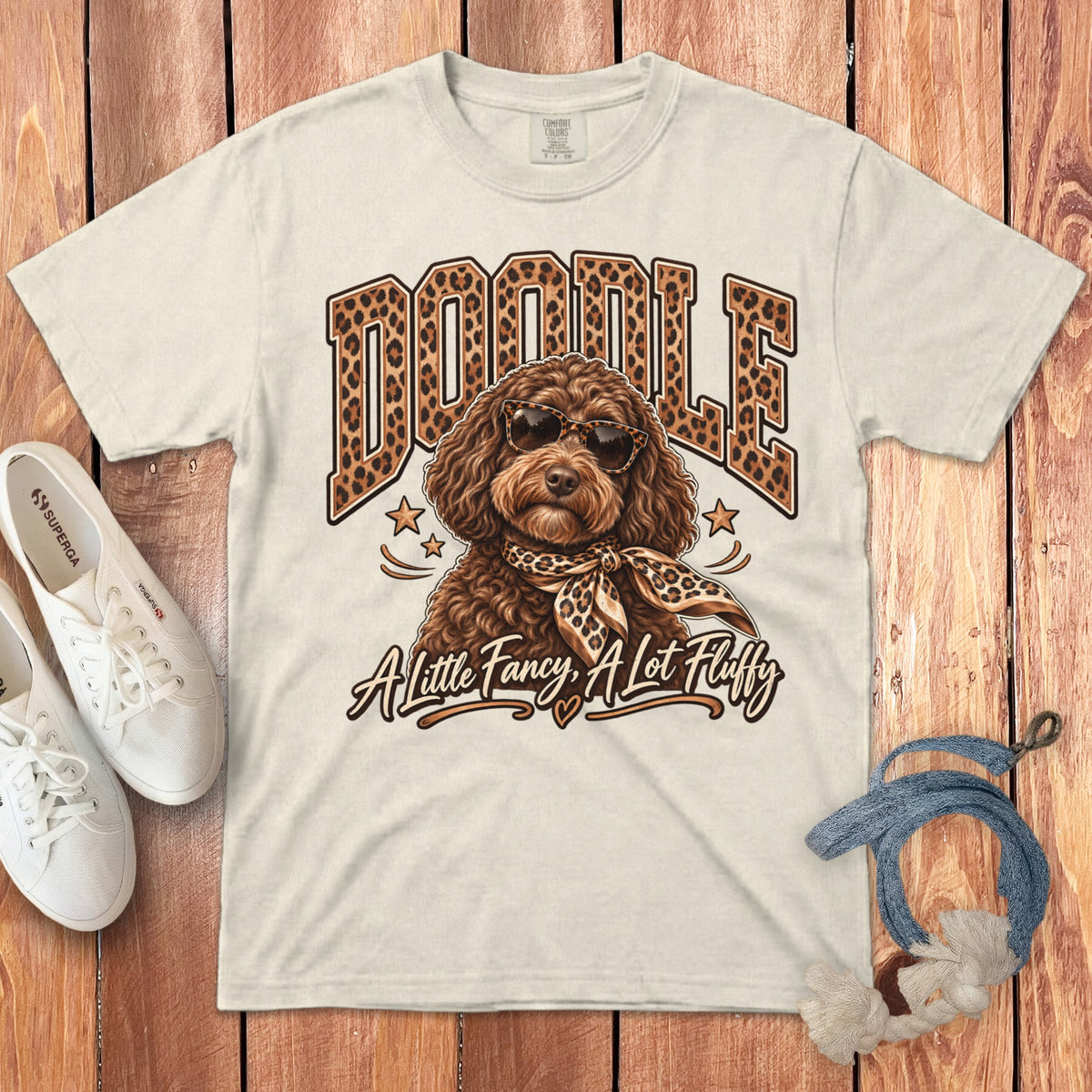 Cream t-shirt with "DOODLE" in leopard print and dog wearing sunglasses and scarf.