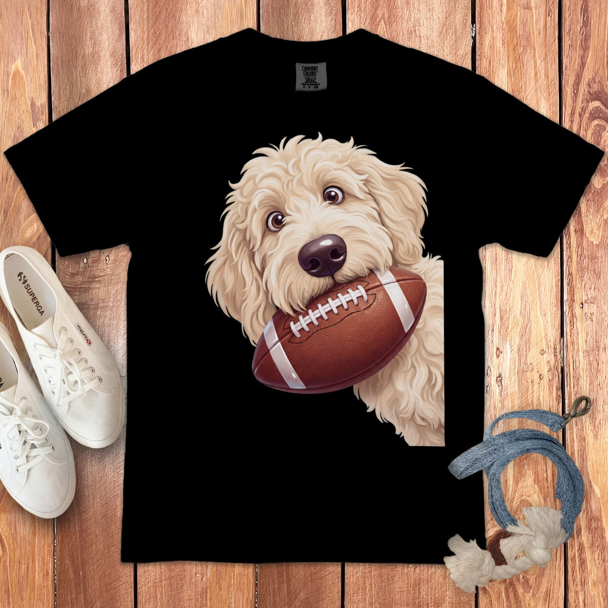 Black t-shirt with a doodle dog holding a football.