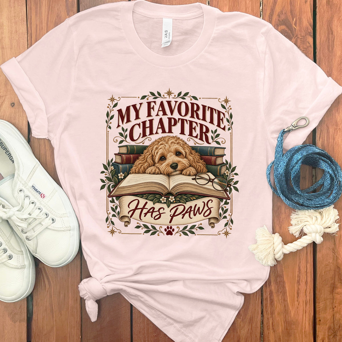 T-shirt with dog on book graphic and text "MY FAVORITE CHAPTER HAS PAWS".