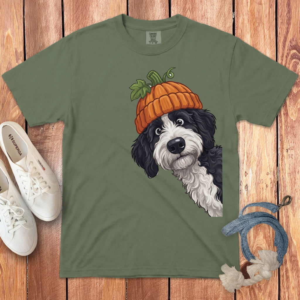 Green t-shirt with a black and white dog wearing a pumpkin hat graphic.