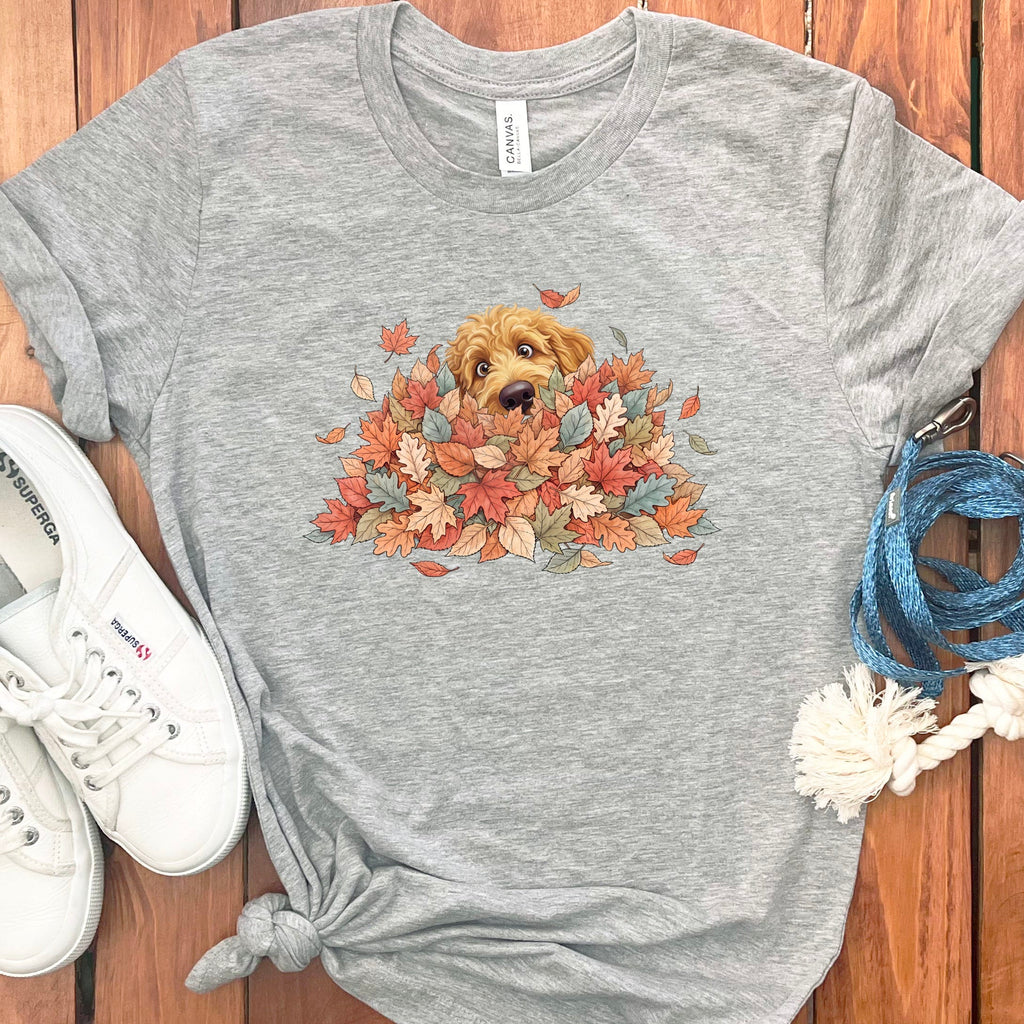 Apricot Goldendoodle Peeking Leaf Pile T-Shirt in Athletic Heather / S by Puppy Jo