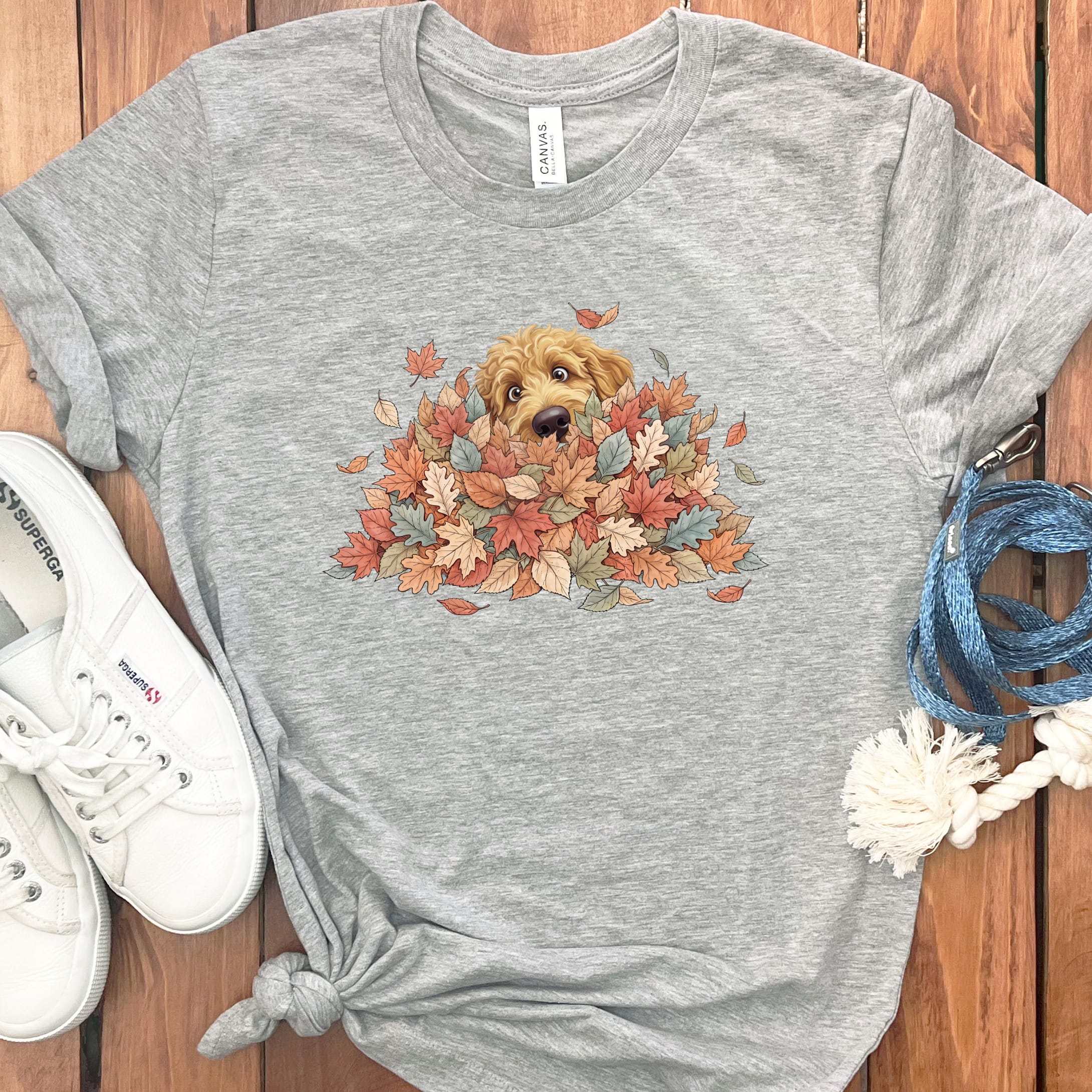 Apricot Goldendoodle Peeking Leaf Pile T-Shirt in Athletic Heather / S by Puppy Jo