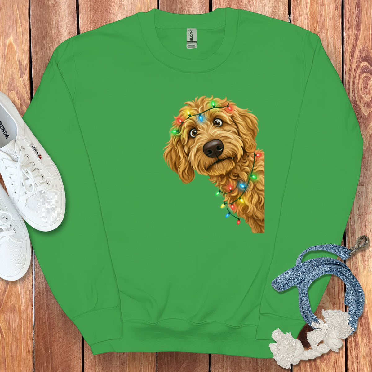 Green crewneck sweatshirt with a fluffy dog wearing Christmas lights.