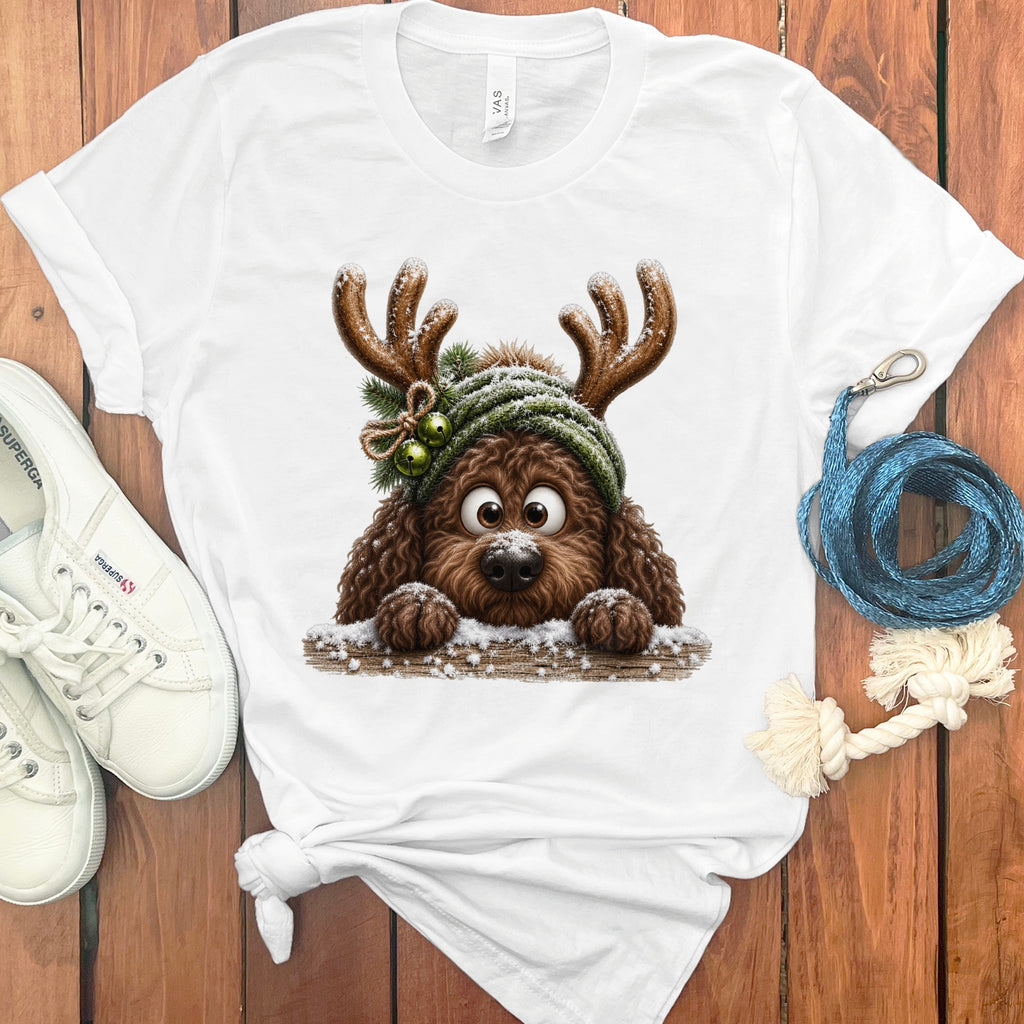 White t-shirt with brown doodle dog wearing reindeer antlers and a green hat.