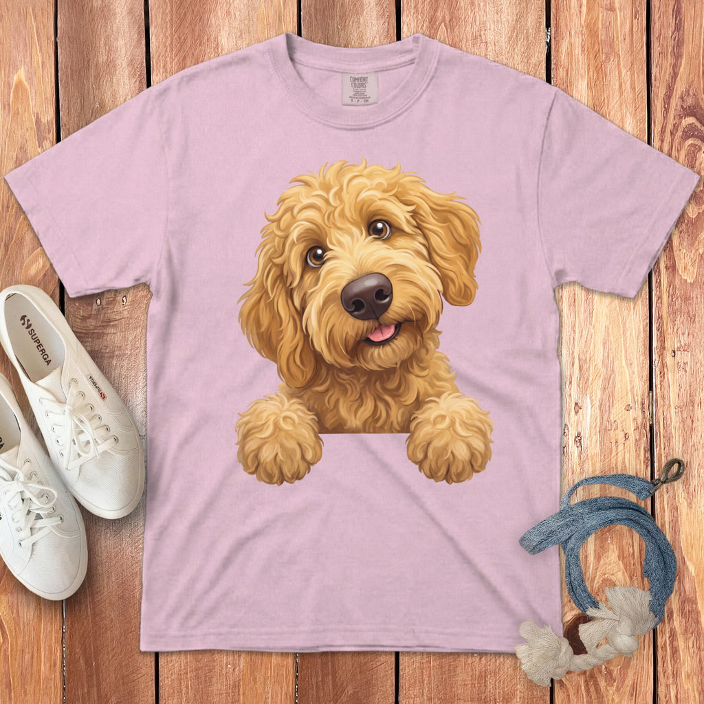 Pink t-shirt with a golden doodle puppy illustration, white Superga sneakers, and a rope dog toy.