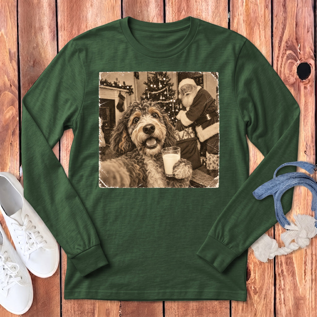 Forest green long-sleeve t-shirt featuring a graphic of a dog holding a glass of milk with Santa in the background.