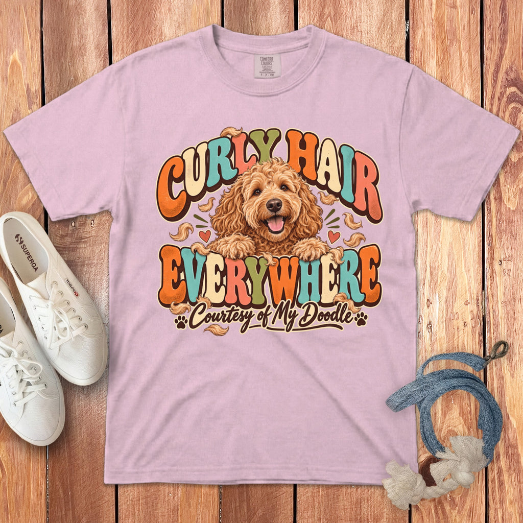 Pink t-shirt with a graphic of a doodle dog and text "Curly Hair Everywhere Courtesy of My Doodle."