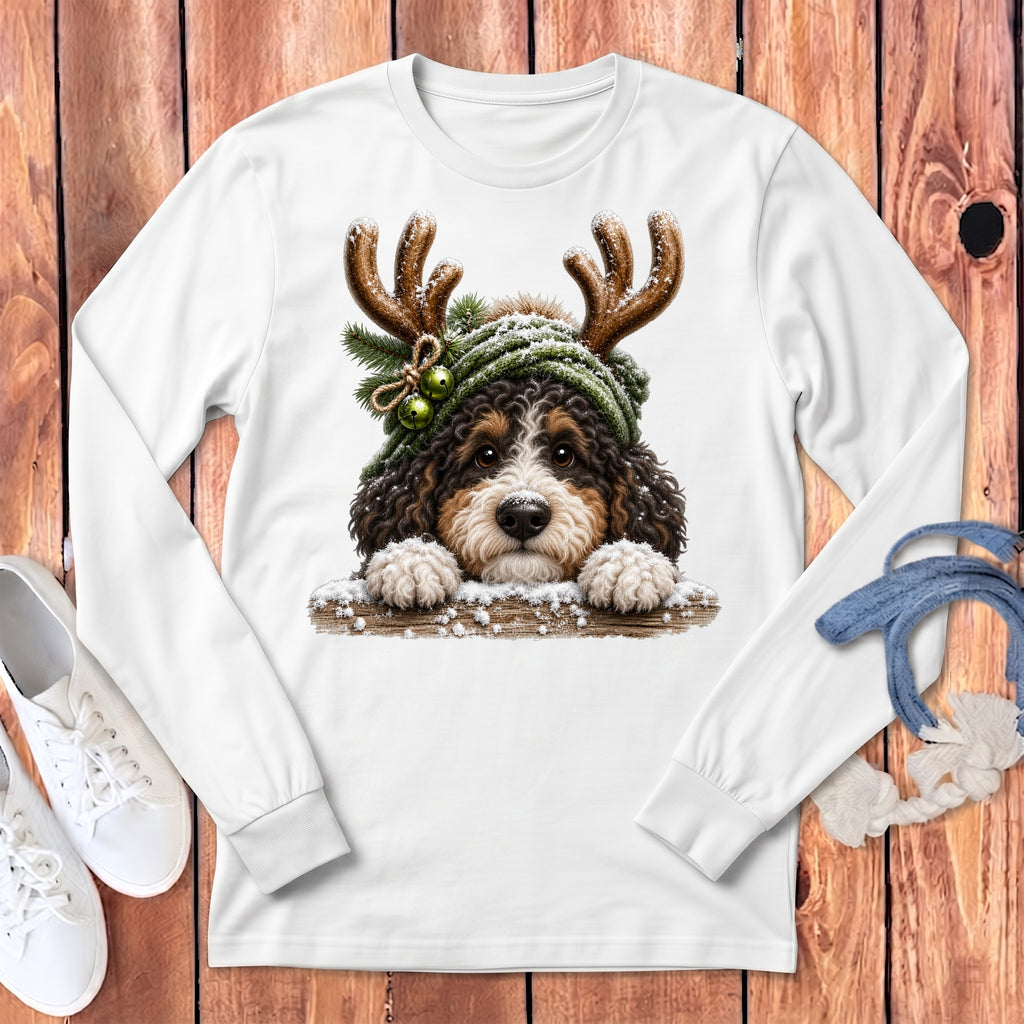 Bernese Mountain Dog puppy wearing antlers and a green hat with jingle bells.