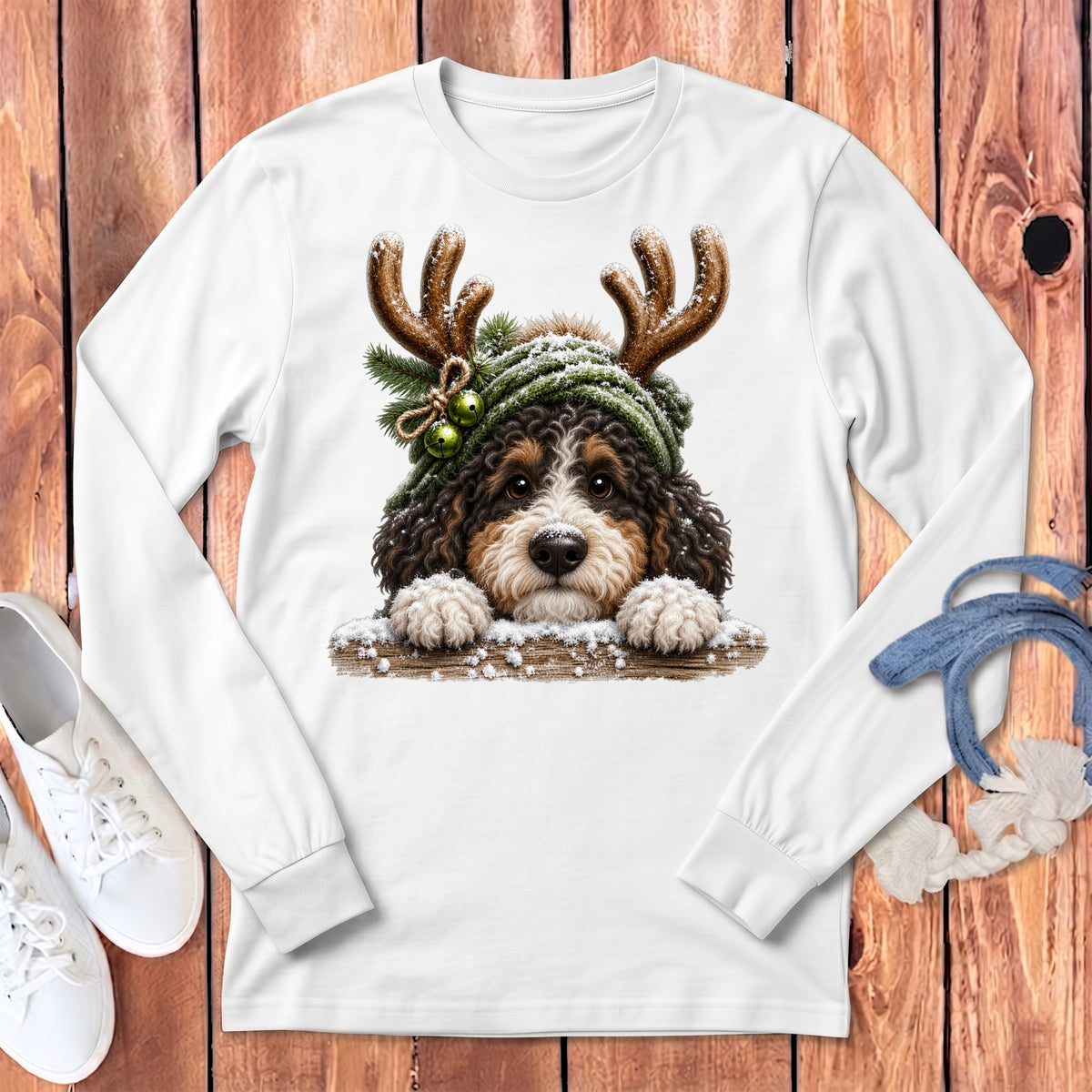 Bernese Mountain Dog puppy wearing antlers and a green hat with jingle bells.