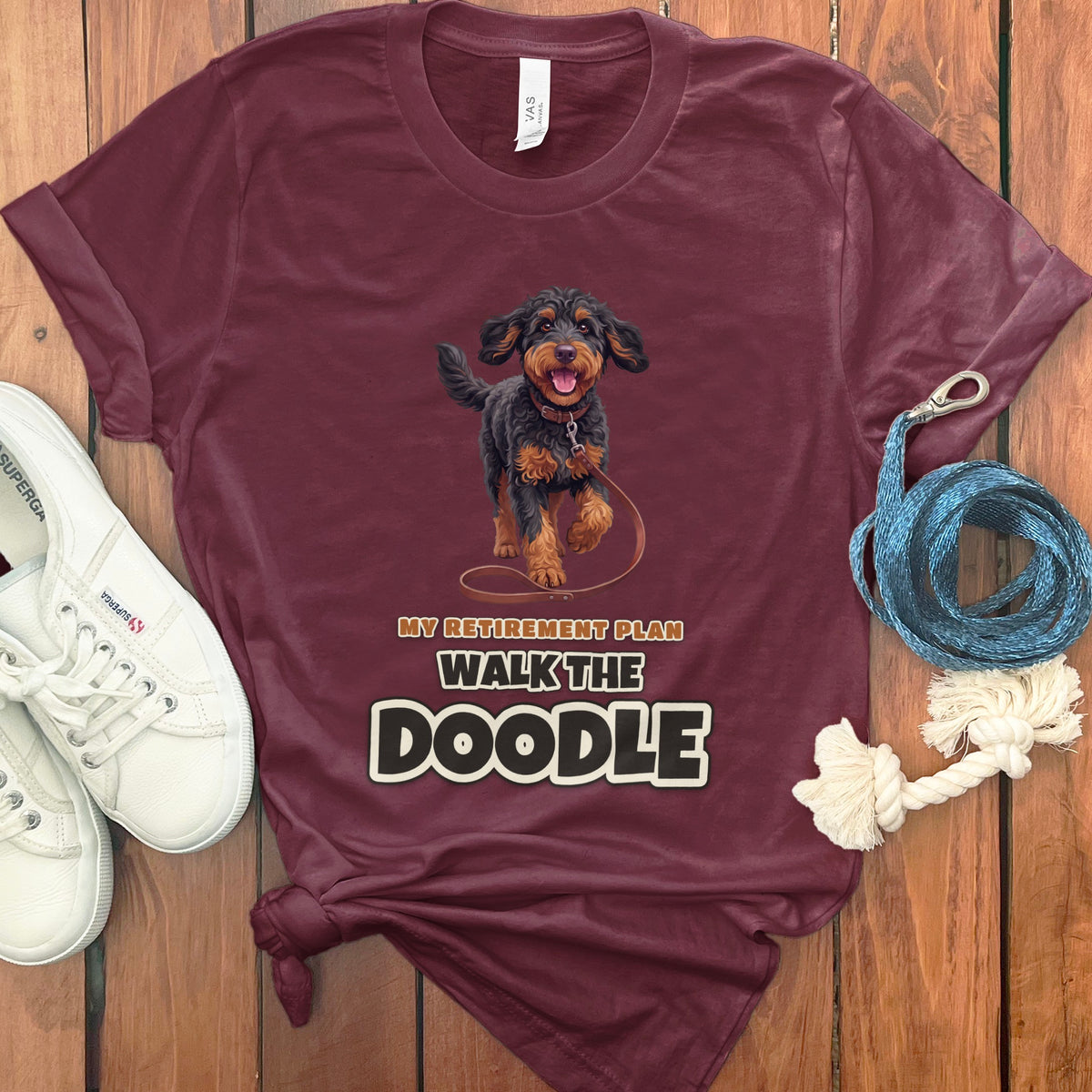 Maroon t-shirt with a doodle dog graphic and text "MY RETIREMENT PLAN WALK THE DOODLE."