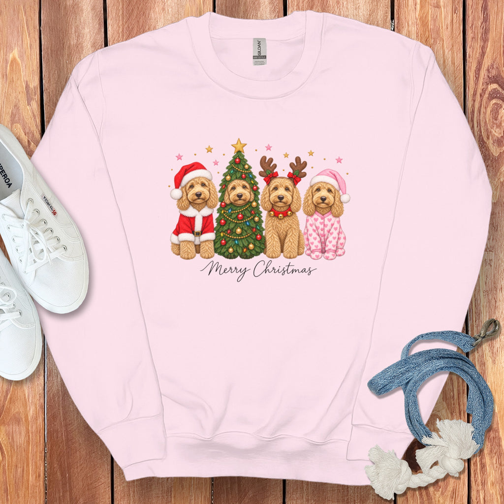 Light pink crewneck sweatshirt with a graphic of four doodle dogs celebrating Christmas above the text Merry Christmas.