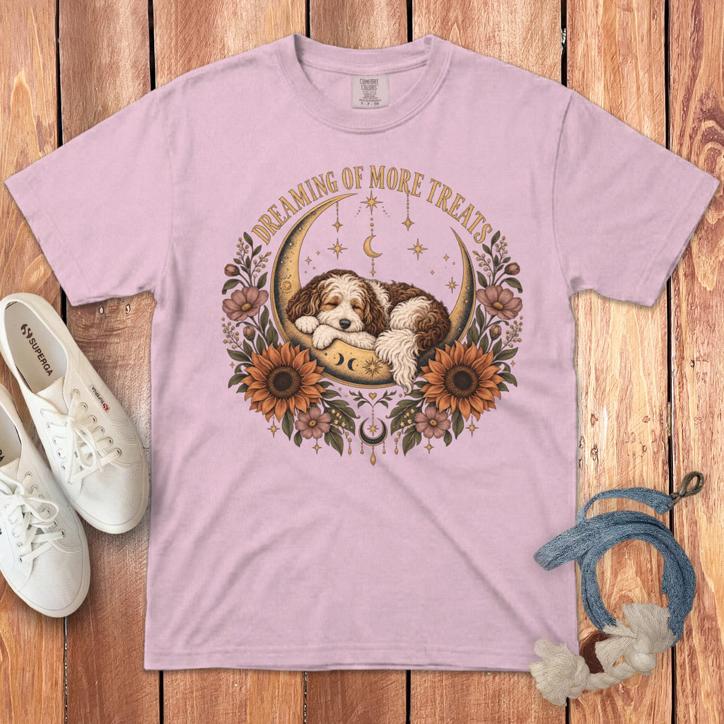 Light pink short-sleeve t-shirt with a graphic of a sleeping puppy on a crescent moon, surrounded by sunflowers.