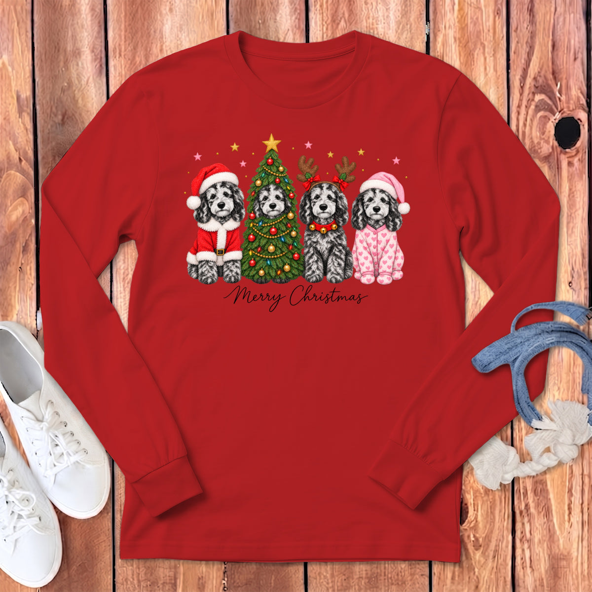 A red long-sleeve shirt displays four cartoon dogs dressed for Christmas, with text reading Merry Christmas.