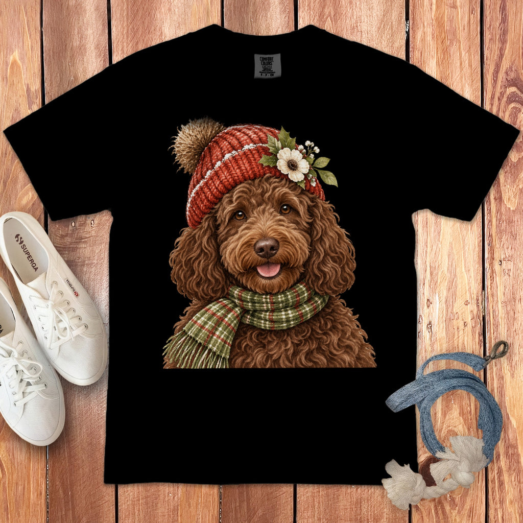 Black t-shirt with a drawing of a brown doodle wearing a red beanie and scarf.