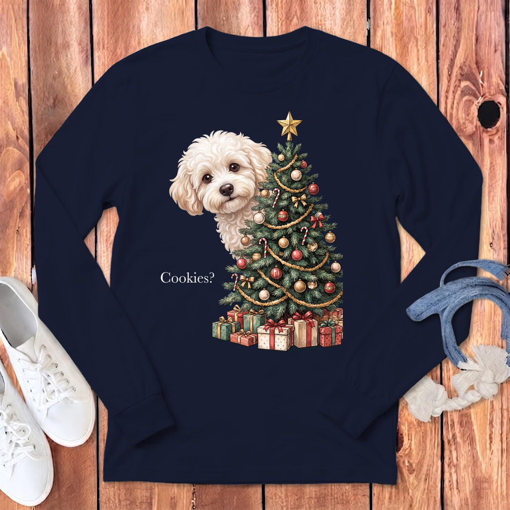 White dog peeking behind a decorated Christmas tree and presents, text "Cookies?".