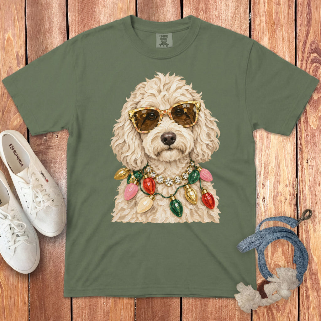 Green t-shirt with a white fluffy dog wearing sunglasses and a string of Christmas lights.