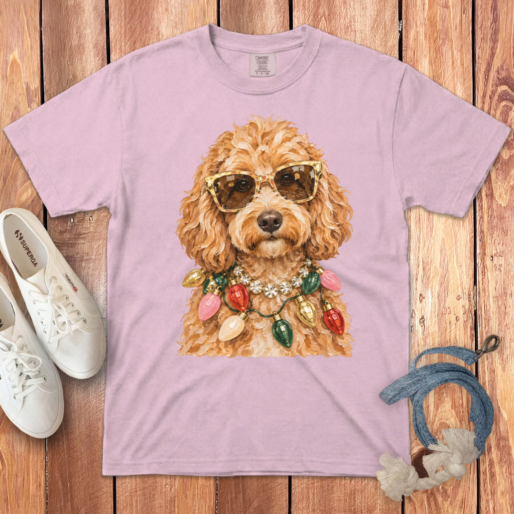 Pink t-shirt with a gold-sunglassed dog wearing a string of colorful Christmas lights.