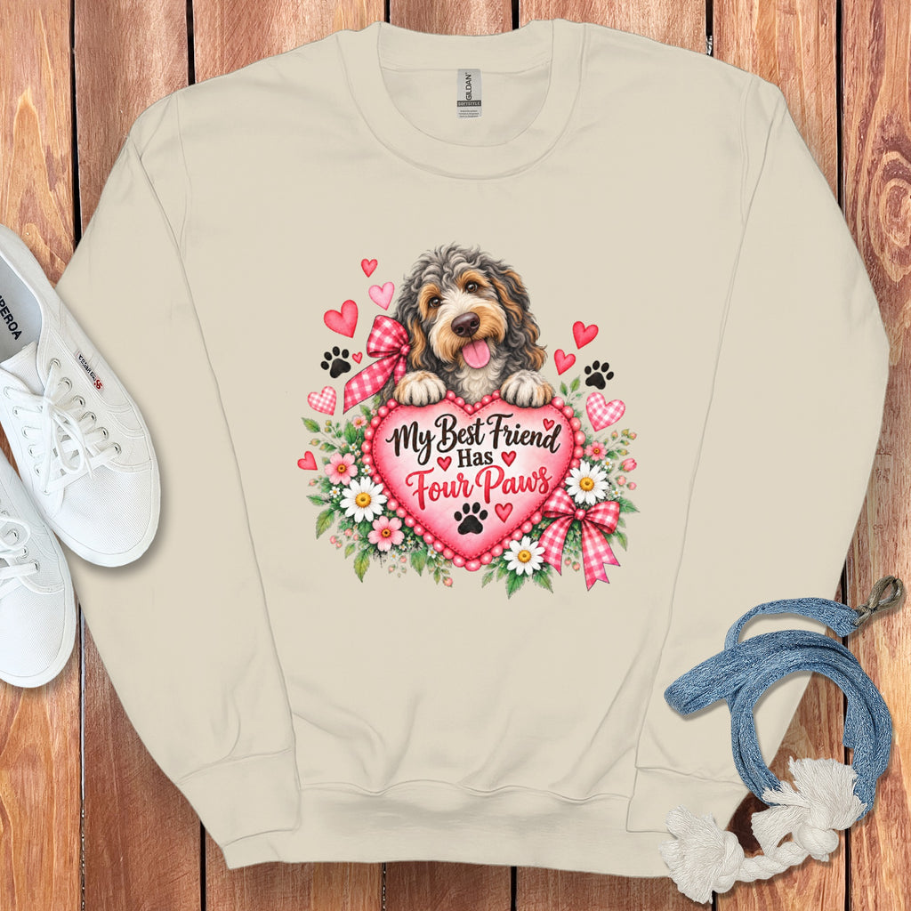 Beige crewneck sweatshirt with a graphic of a dog, hearts, flowers, and the text "My Best Friend Has Four Paws".