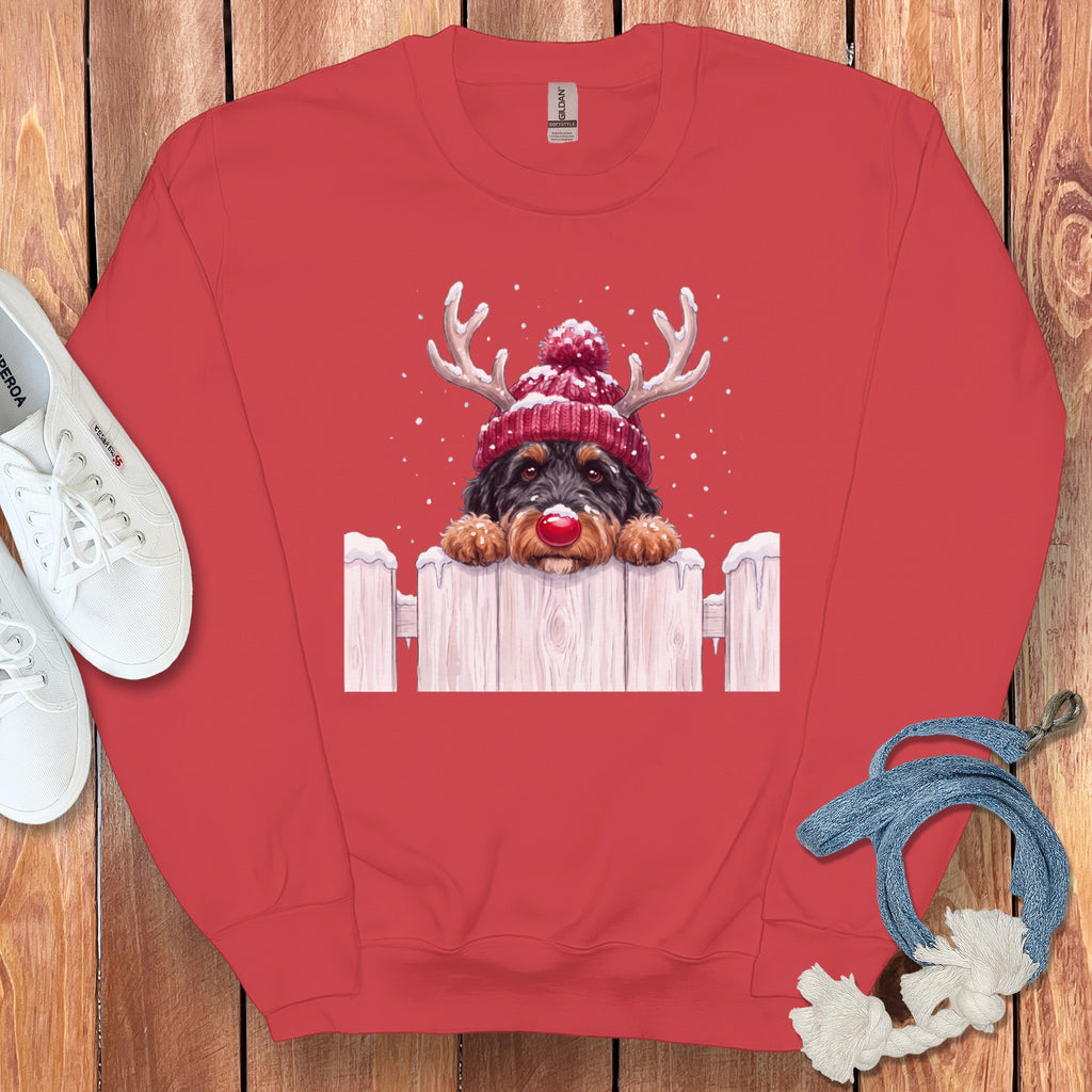 Dog with reindeer antlers and red nose on a snowy fence design.