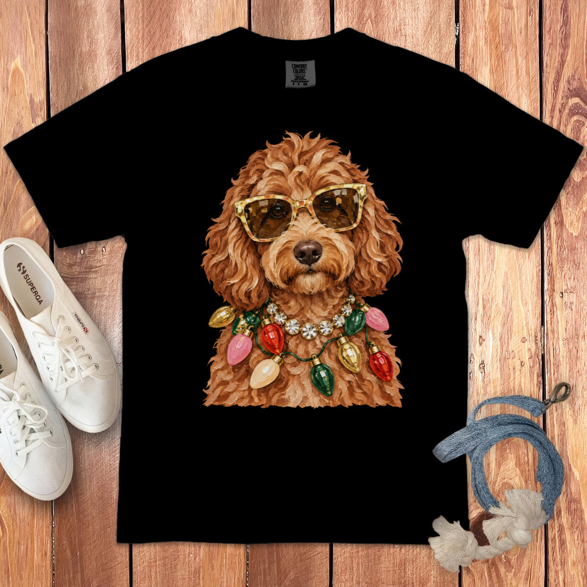 Black t-shirt with watercolor print of a dog wearing sunglasses and Christmas lights.