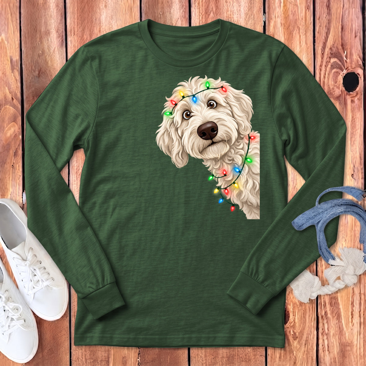 Green long-sleeved shirt with a doodle dog wearing colorful Christmas lights graphic.