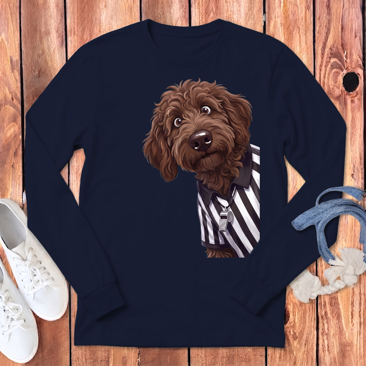Brown doodle dog wearing a referee shirt with a whistle on a navy long-sleeve shirt.