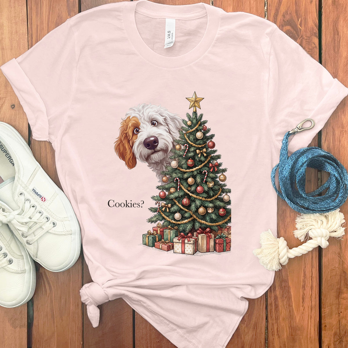 Pink t-shirt with dog peeking behind decorated Christmas tree and text "Cookies?".