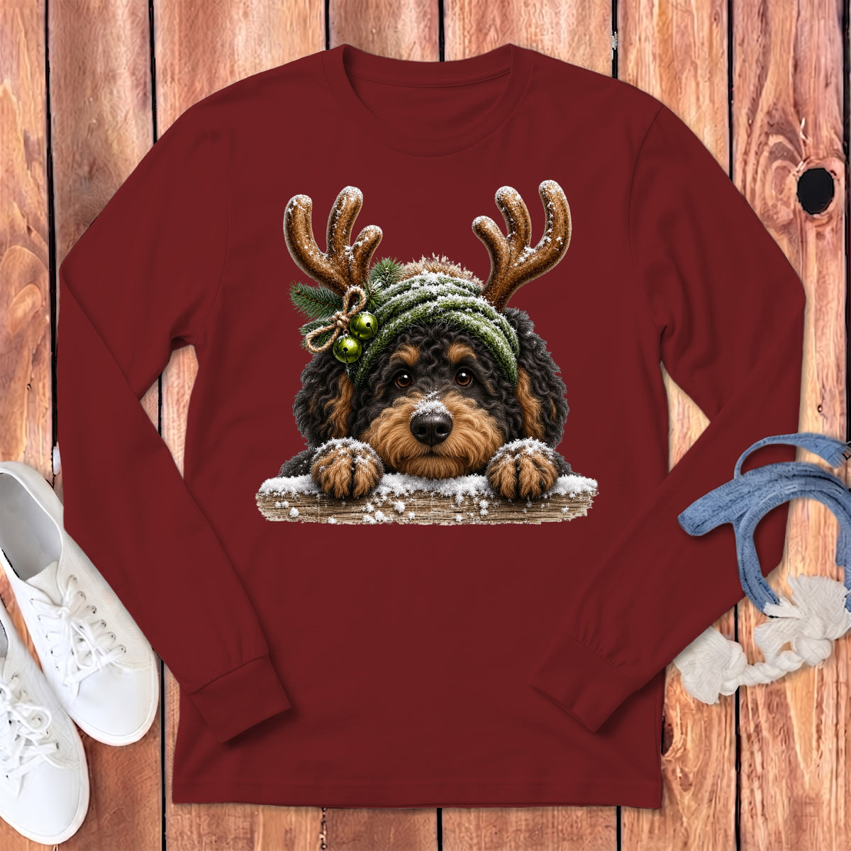 Maroon long-sleeve shirt with a doodle dog wearing reindeer antlers and a winter hat.