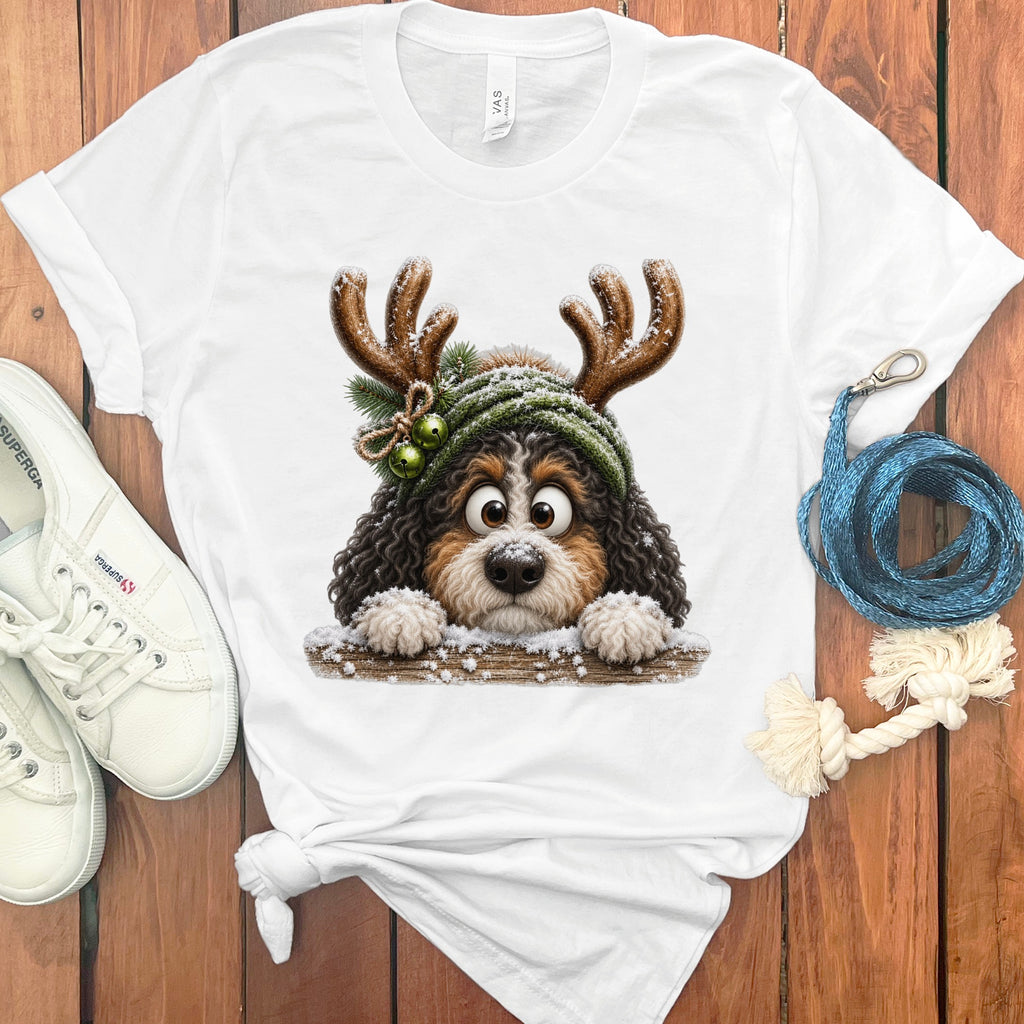 White t-shirt with a Bernese Mountain Dog wearing reindeer antlers and a beanie.