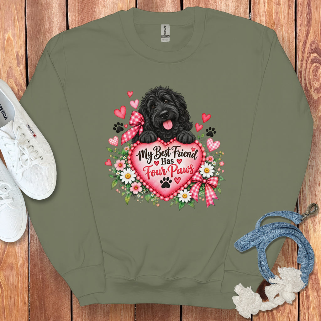 An olive green crewneck sweatshirt featuring a graphic of a black dog, hearts, and text reading "My Best Friend Has Four Paws".