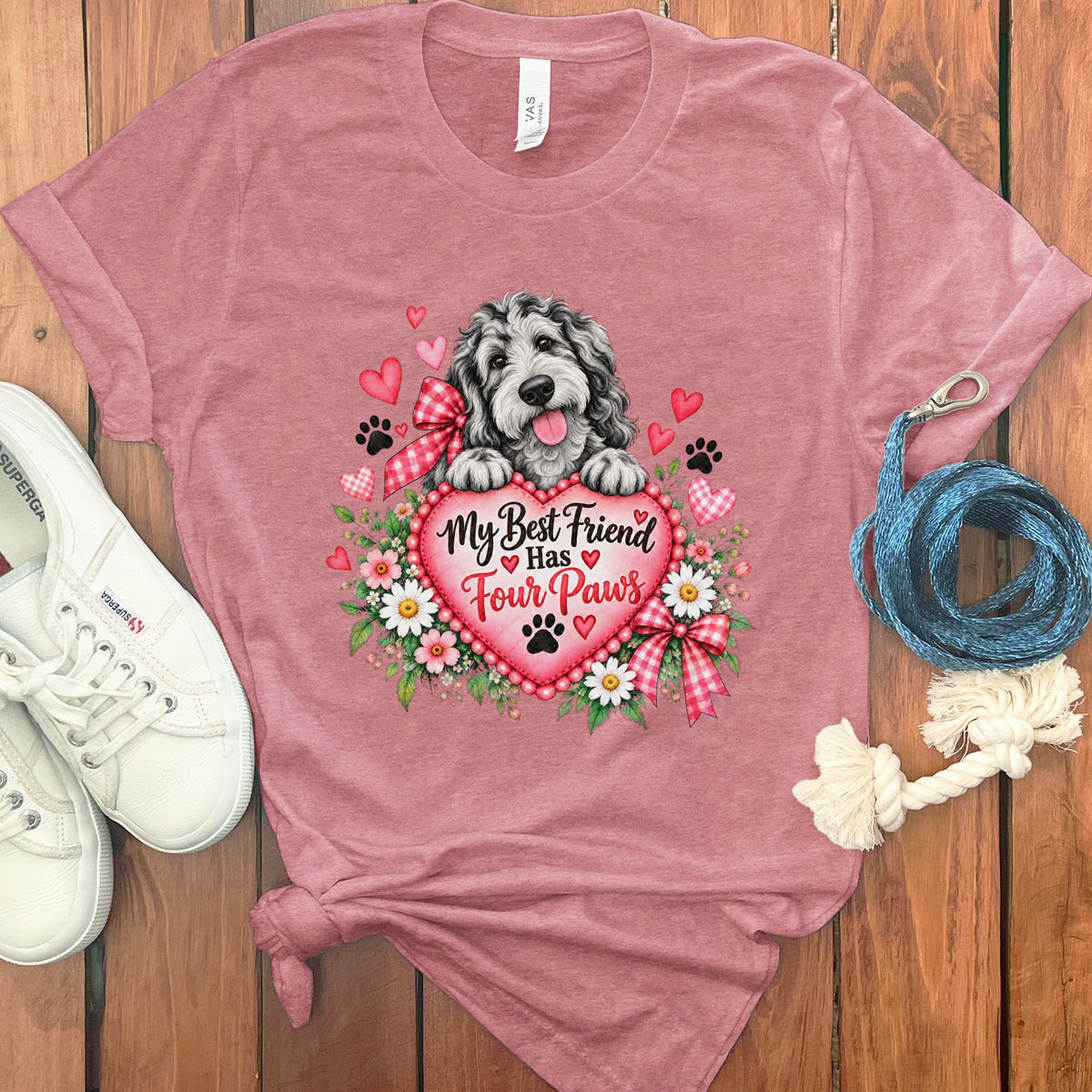 Heather pink t-shirt featuring a cartoon dog behind a heart with text My Best Friend Has Four Paws.