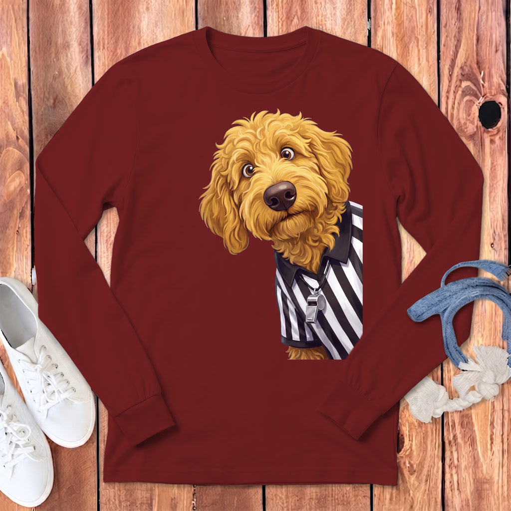Goldendoodle wearing a referee shirt with whistle on a maroon long-sleeve shirt.