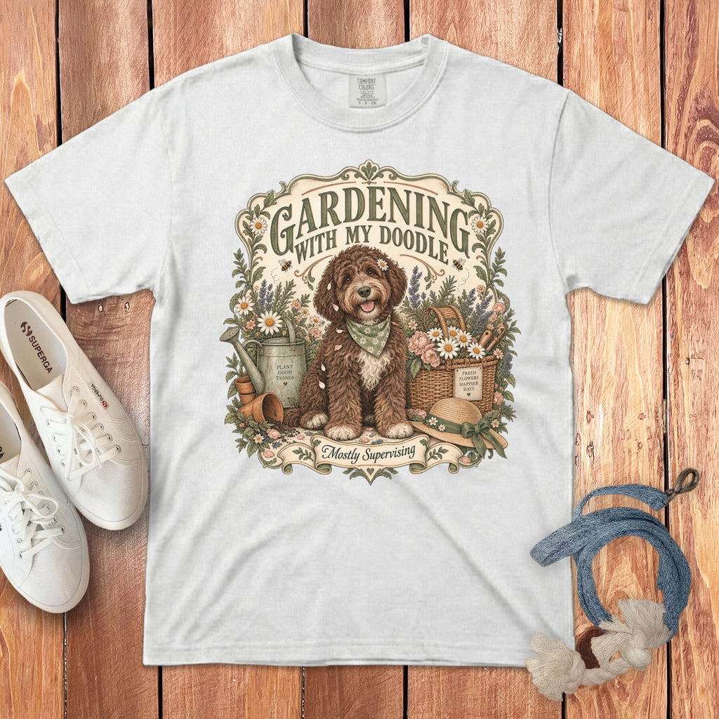 White t-shirt with doodle dog, gardening tools, and text "Gardening With My Doodle".