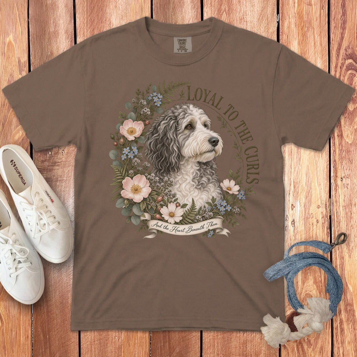 Brown t-shirt with a dog portrait surrounded by flowers and text "Loyal to the Curls".