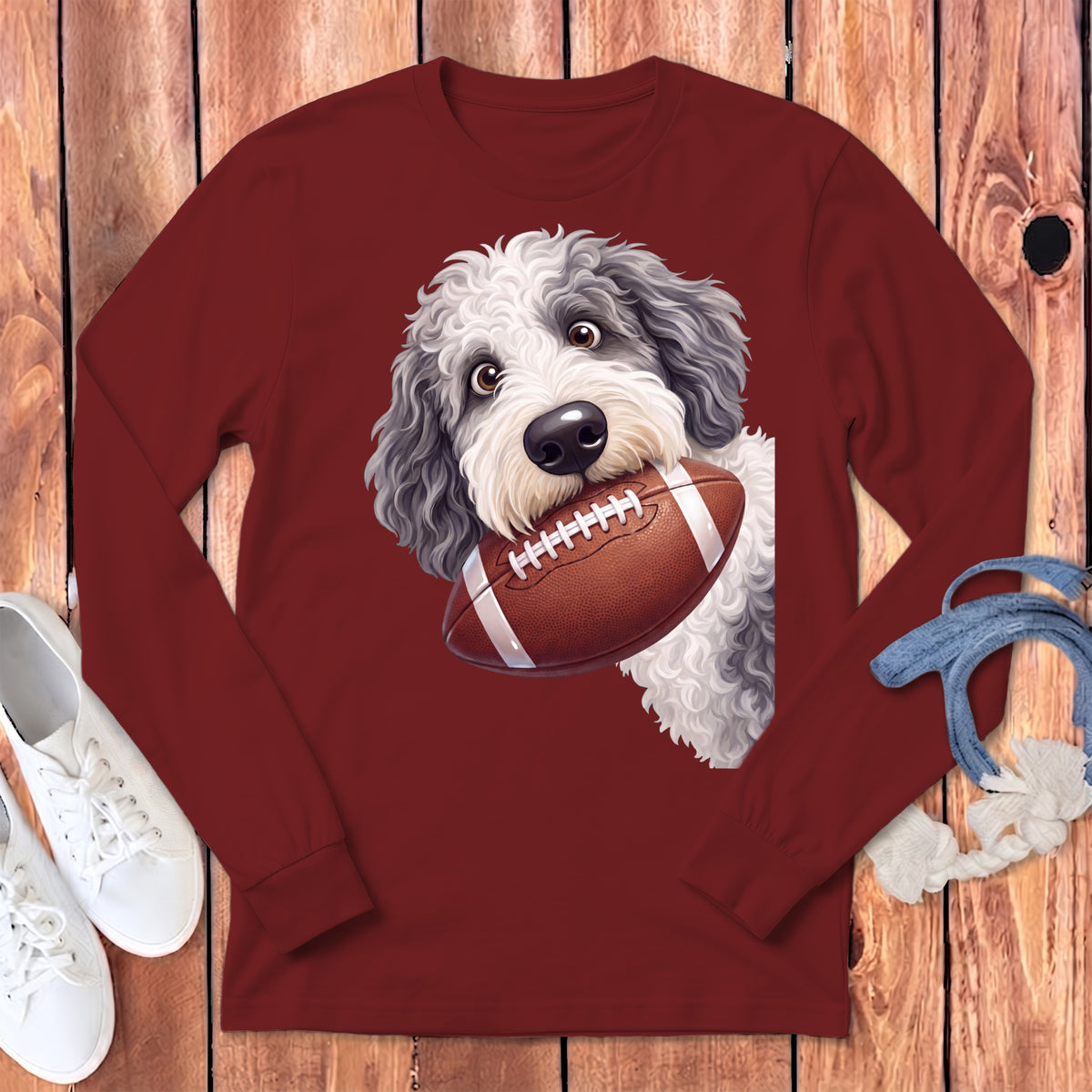 Maroon long-sleeve shirt featuring a doodle dog holding a football.