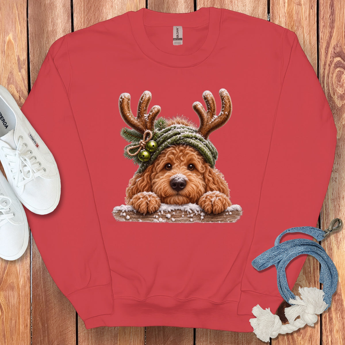 Red crewneck sweatshirt with a printed image of a fluffy dog wearing antlers and a hat.