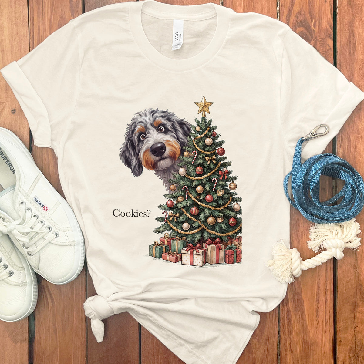 Dog peeking out from behind a decorated Christmas tree with gifts and "Cookies?" text.