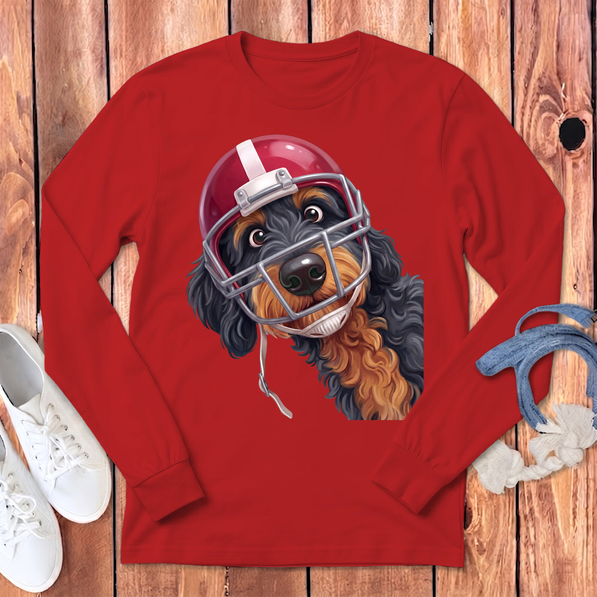 A cartoon dog wearing a red football helmet looks out from a red long-sleeved shirt.