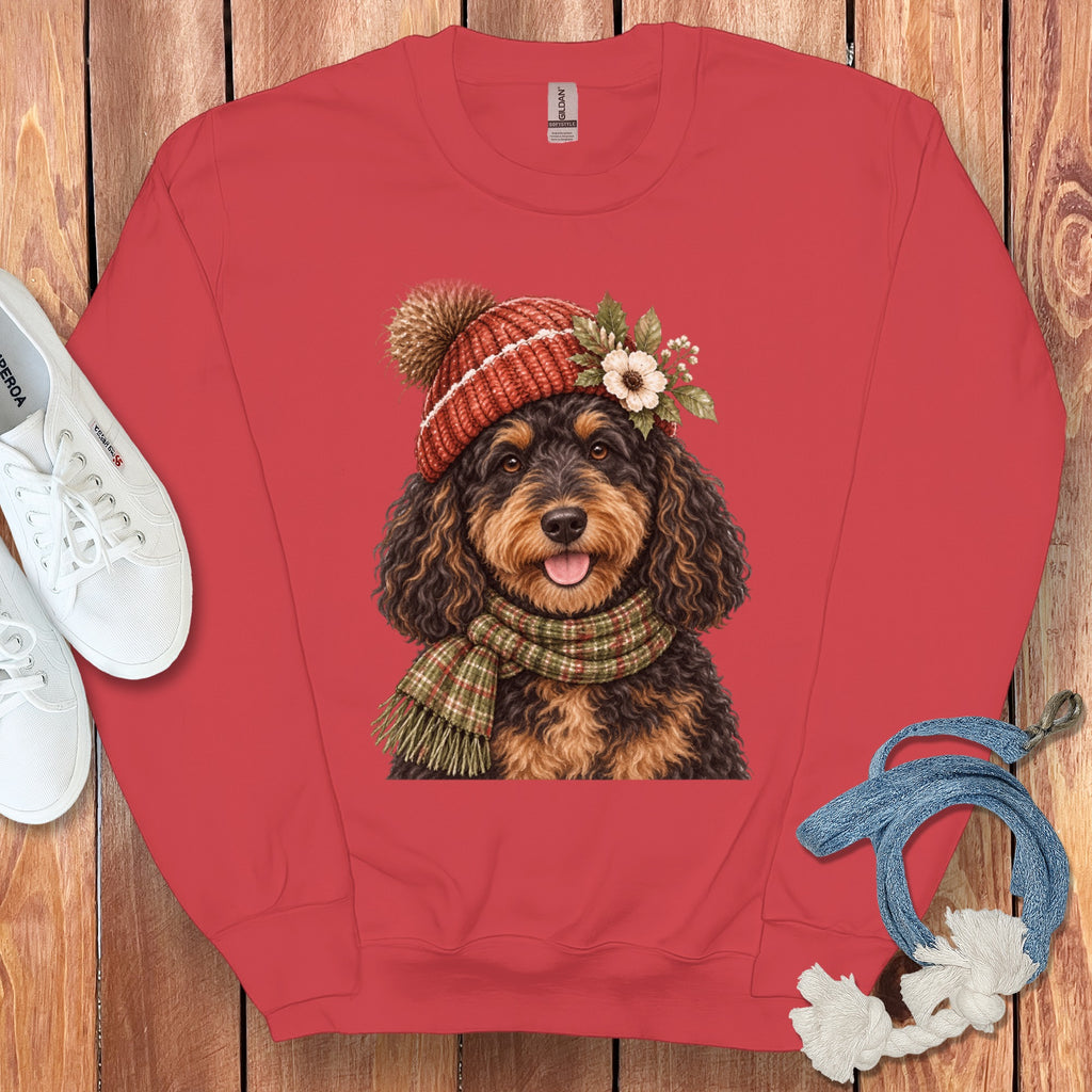 Red sweatshirt with doodle dog wearing a knit hat and scarf.