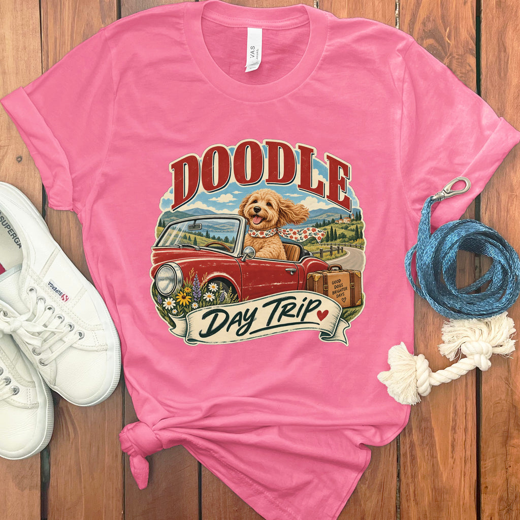 Pink t-shirt with doodle dog driving a convertible, text "Doodle Day Trip".