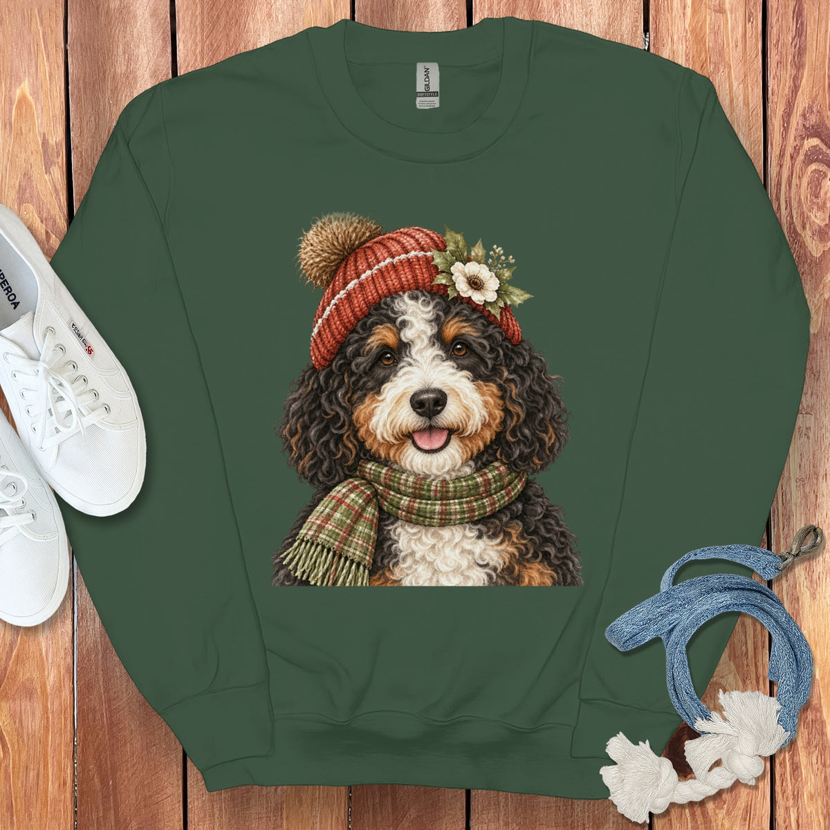 Dark green sweatshirt with Bernese Mountain Dog graphic wearing a beanie and scarf.