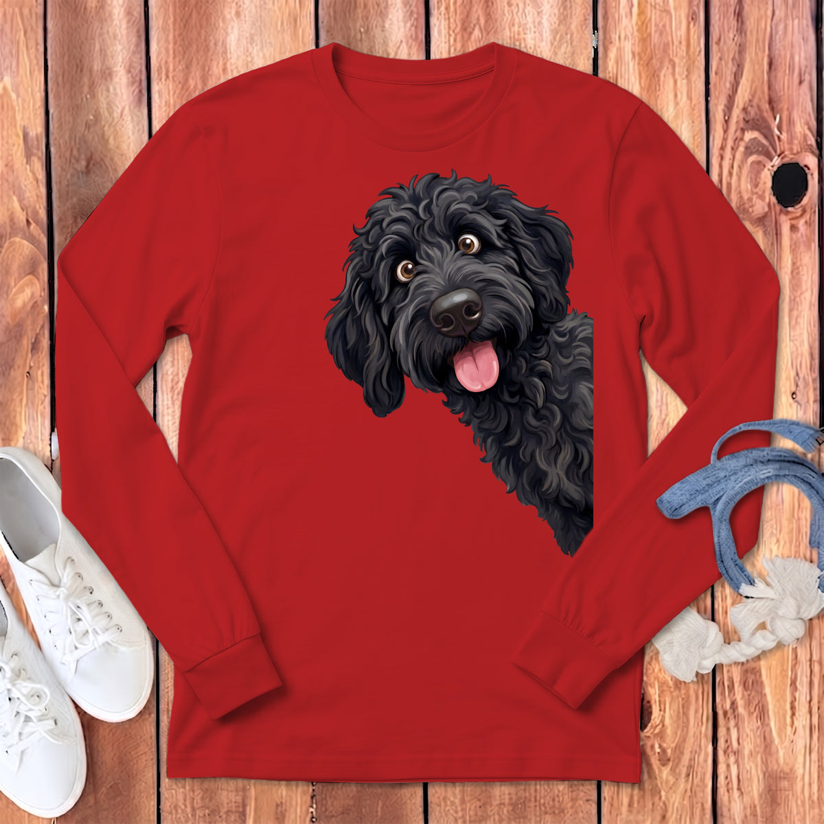Black dog illustration peeking from the side on a red long-sleeve shirt.
